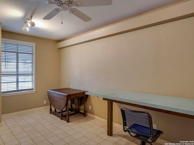 office area featuring baseboards, a ceiling fan, built in desk, track lighting, and light tile patterned flooring