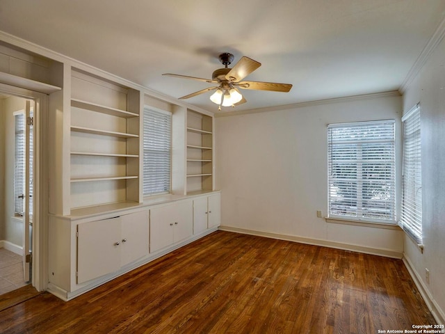 unfurnished bedroom featuring baseboards, ornamental molding, ceiling fan, and dark wood-style flooring