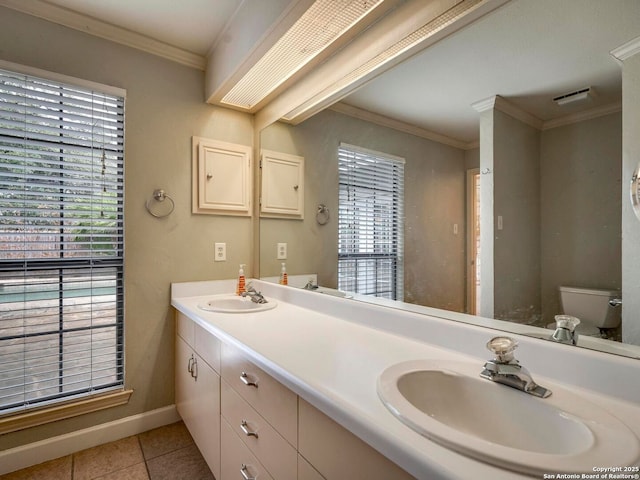 bathroom featuring double vanity, toilet, ornamental molding, tile patterned floors, and a sink