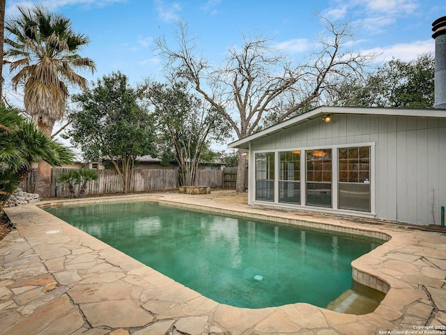 view of swimming pool with a fenced backyard, a fenced in pool, and a patio