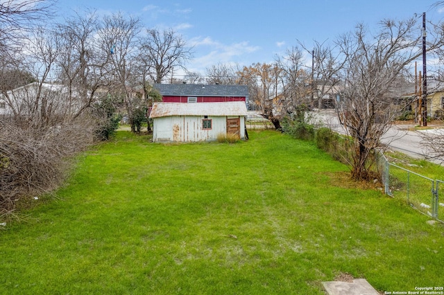 view of yard featuring an outbuilding and fence