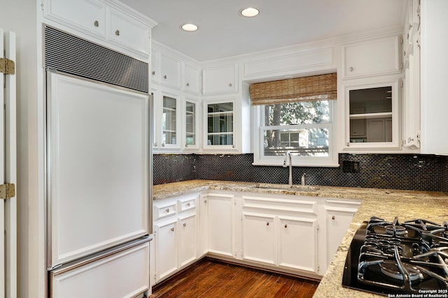 331 Ridgemont, Terrell Hills, TX 78209 - kitchen featuring paneled fridge, black gas cooktop, dark wood-style flooring, white cabinets, and backsplash