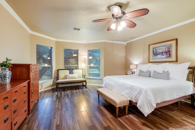 bedroom featuring dark wood-type flooring, visible vents, and crown molding