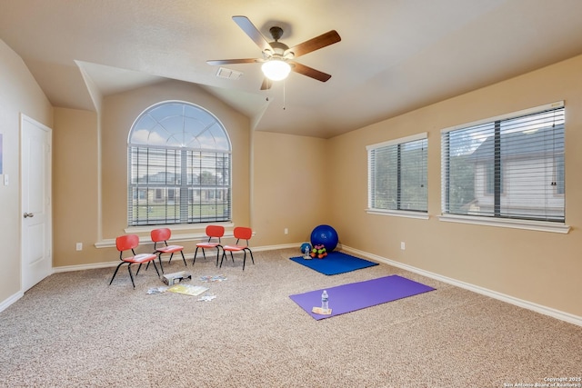 workout room featuring ceiling fan, visible vents, baseboards, vaulted ceiling, and carpet