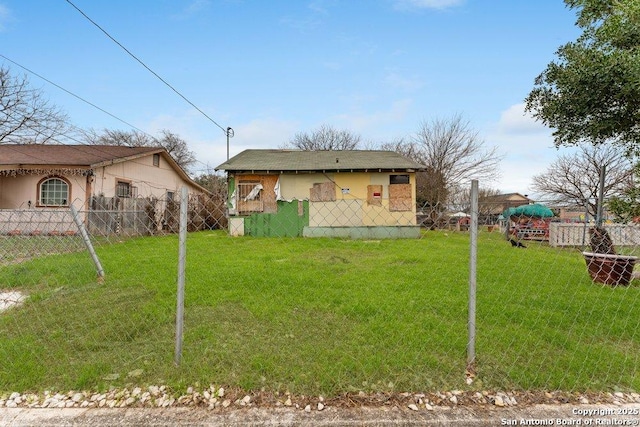 rear view of property with a yard and fence