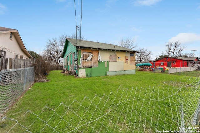 exterior space featuring a yard and fence