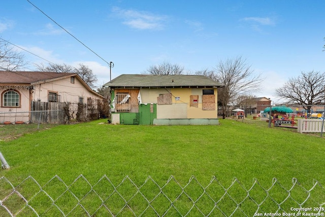 back of house with a yard and fence