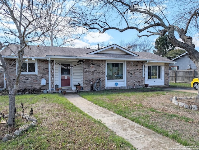 ranch-style house with a front yard, brick siding, fence, and roof with shingles