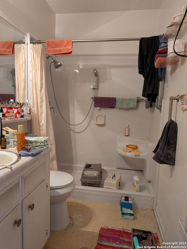 full bath featuring toilet, a shower with curtain, tile patterned flooring, a textured ceiling, and vanity