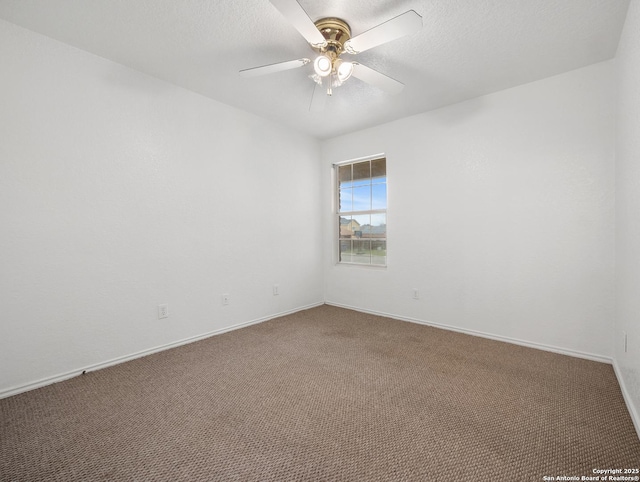 carpeted spare room with ceiling fan, baseboards, and a textured ceiling