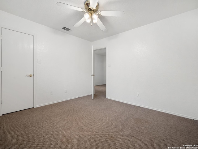 unfurnished bedroom featuring a ceiling fan, baseboards, visible vents, and carpet flooring