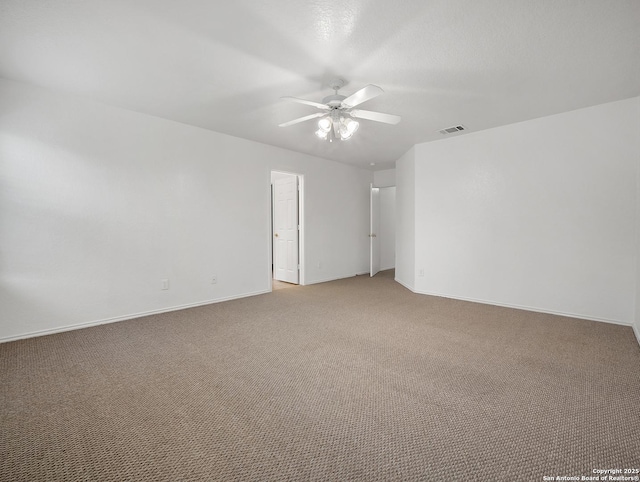 unfurnished room with baseboards, visible vents, ceiling fan, and carpet flooring