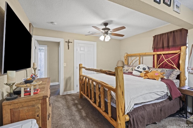 bedroom featuring a textured ceiling, ceiling fan, dark carpet, and baseboards