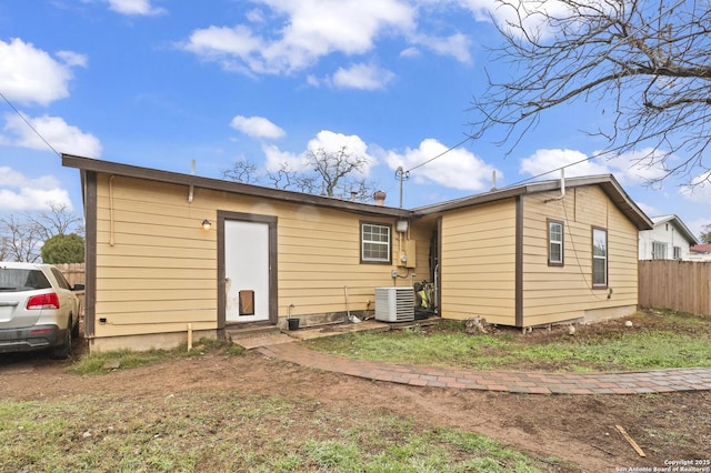 back of house with fence and central air condition unit