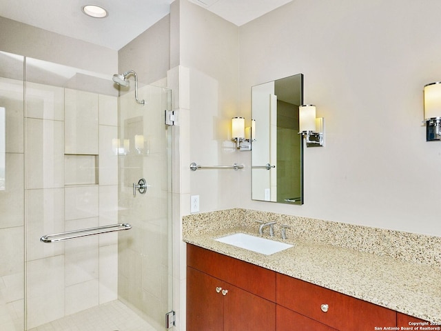 full bath with a shower stall and vanity