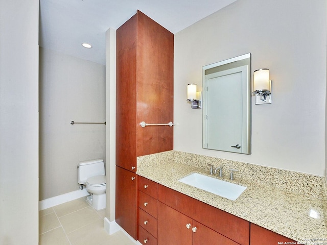 bathroom with vanity, tile patterned flooring, toilet, and baseboards