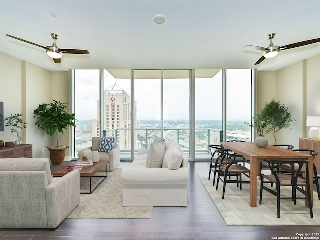 living area featuring a view of city, ceiling fan, wood finished floors, and floor to ceiling windows