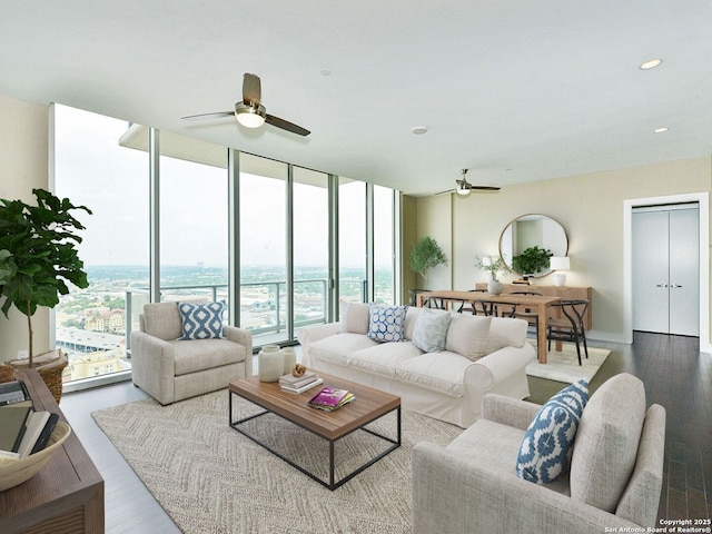 living area featuring a ceiling fan, recessed lighting, floor to ceiling windows, and wood finished floors