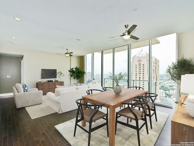 dining room featuring dark wood-style floors, expansive windows, and a ceiling fan