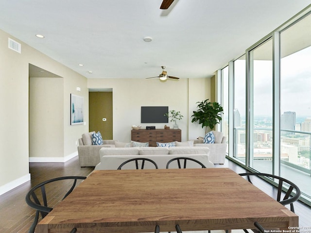 dining area with expansive windows, visible vents, ceiling fan, and wood finished floors