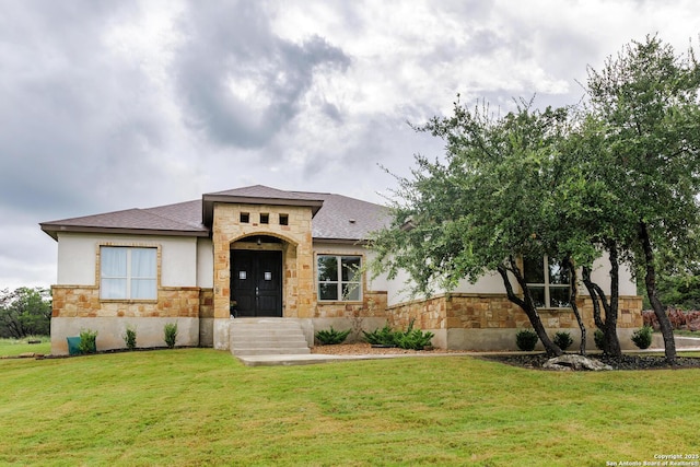 view of front of property featuring stone siding, a front lawn, and stucco siding