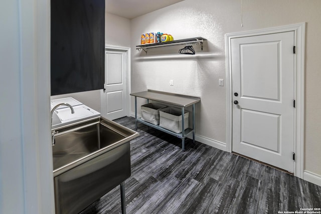 kitchen featuring dark wood-type flooring, a sink, and baseboards