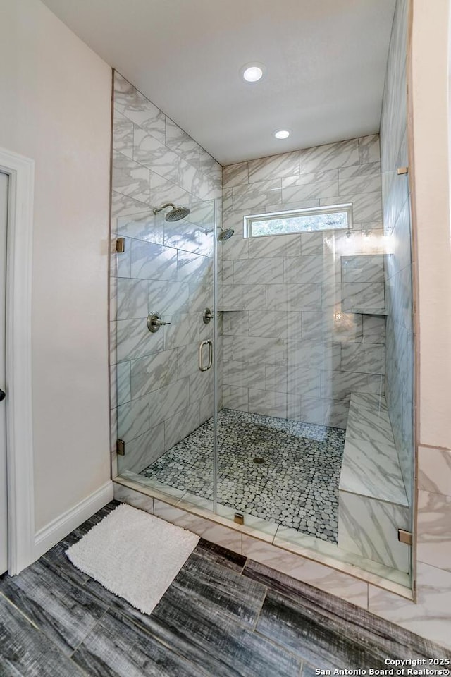 full bath featuring a stall shower, recessed lighting, and baseboards