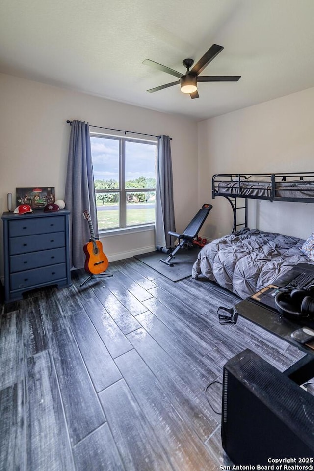 bedroom with dark wood-type flooring and a ceiling fan