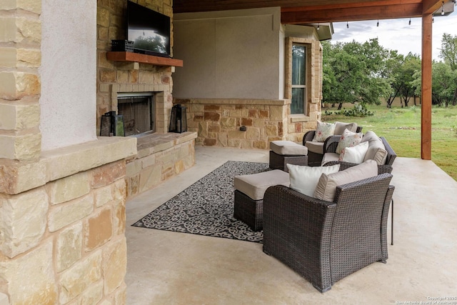 view of patio featuring an outdoor stone fireplace