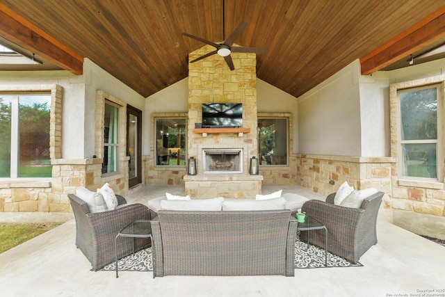 view of patio / terrace featuring an outdoor living space with a fireplace and a ceiling fan