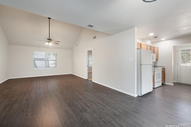 unfurnished living room featuring lofted ceiling, dark wood finished floors, visible vents, and baseboards