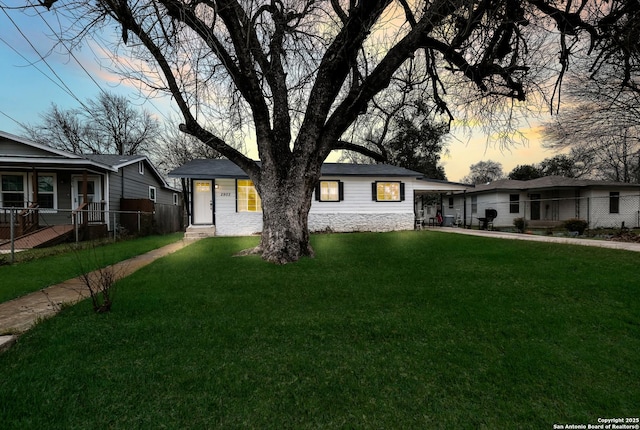 view of front of home with fence, a front lawn, and concrete driveway