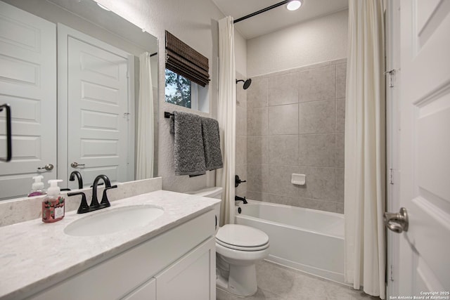 full bath featuring shower / bath combination with curtain, a textured wall, toilet, vanity, and tile patterned floors