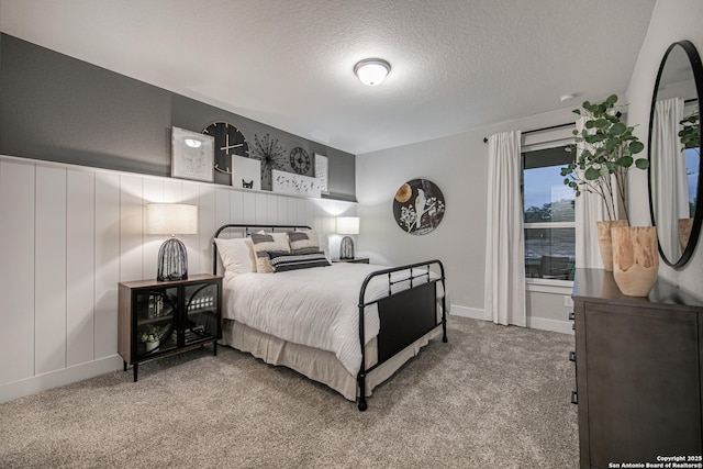 bedroom with light carpet and a textured ceiling