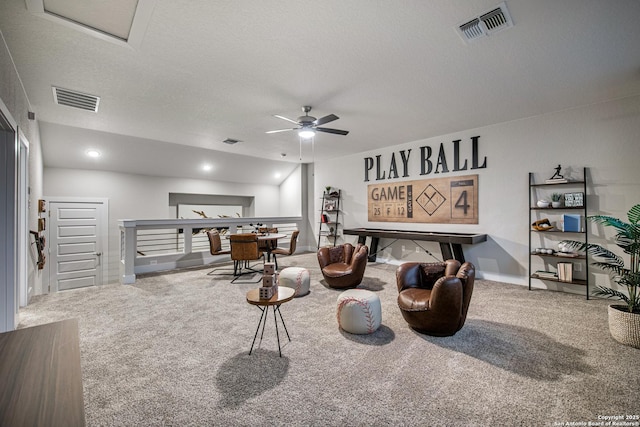 living area featuring a textured ceiling, carpet, and visible vents