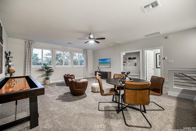 interior space featuring visible vents, a textured ceiling, and baseboards