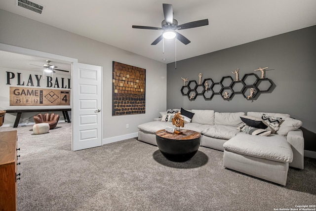 living room featuring carpet floors, baseboards, visible vents, and ceiling fan