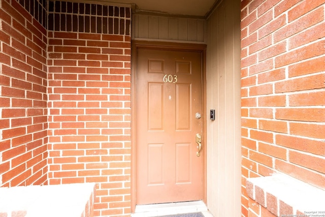 entrance to property with brick siding