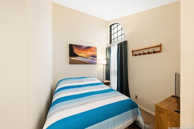 carpeted bedroom featuring baseboards