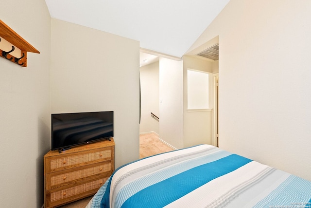 bedroom with lofted ceiling and visible vents