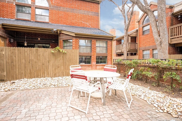 view of patio with fence and outdoor dining space