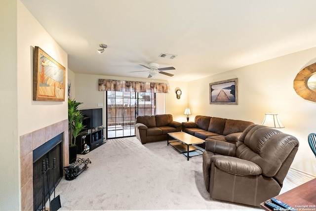 living room with light colored carpet, visible vents, a fireplace, and ceiling fan