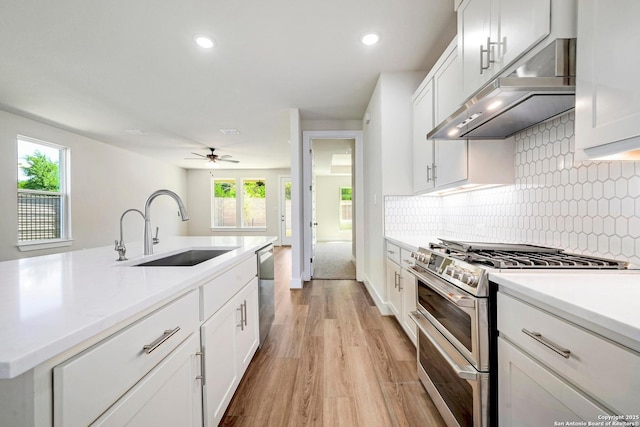 18414 Rhone Riv, San Antonio, TX 78256 - kitchen featuring appliances with stainless steel finishes, light wood finished floors, under cabinet range hood, healthy amount of natural light, and recessed lighting