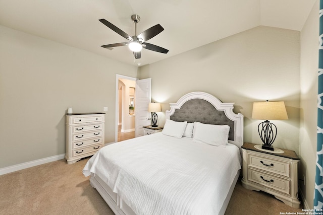 bedroom with light carpet, baseboards, vaulted ceiling, and a ceiling fan