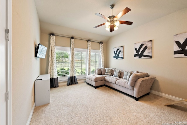 carpeted living area featuring vaulted ceiling, ceiling fan, and baseboards