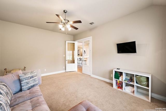 living room with light carpet, ceiling fan, visible vents, and baseboards