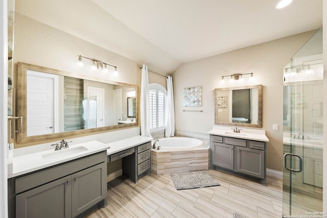 bathroom with lofted ceiling, a shower stall, a sink, and a bath