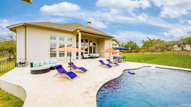 back of property with a fenced in pool, a lawn, a fenced backyard, a patio area, and outdoor lounge area