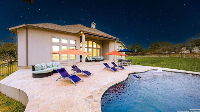 back of property with fence, an outdoor hangout area, a fenced in pool, and a patio