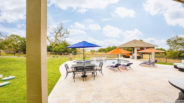 view of patio / terrace featuring outdoor dining space, fence, and a gazebo